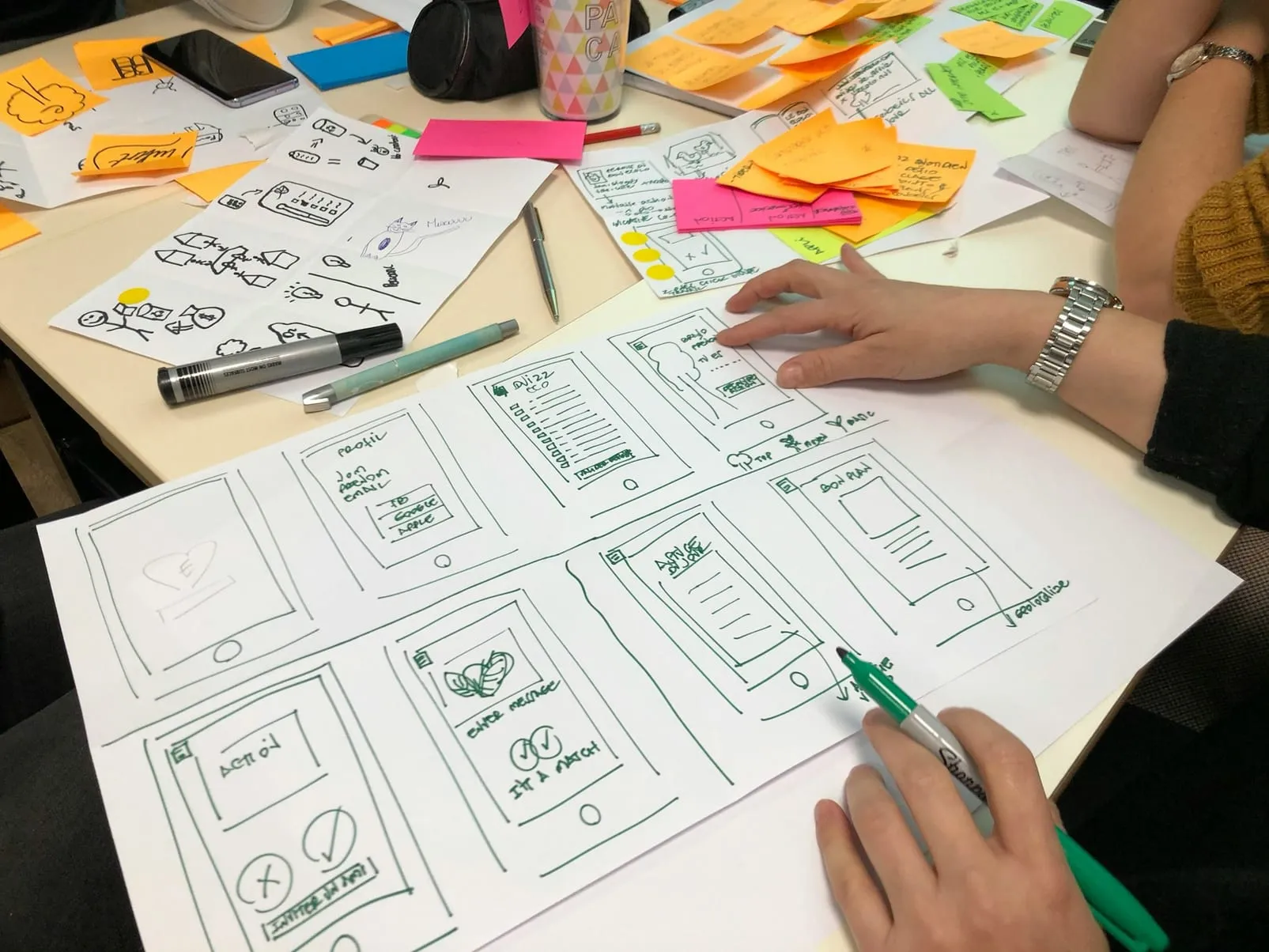 Planning a user interface with wireframe sketches and sticky notes