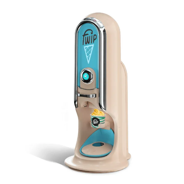 The Fwip frozen dessert machine, a tall cream coloured column with a turquoise front panel carrying the Fwip cone logo, a round display button and a tub of yellow gelato in the dispensing recess.