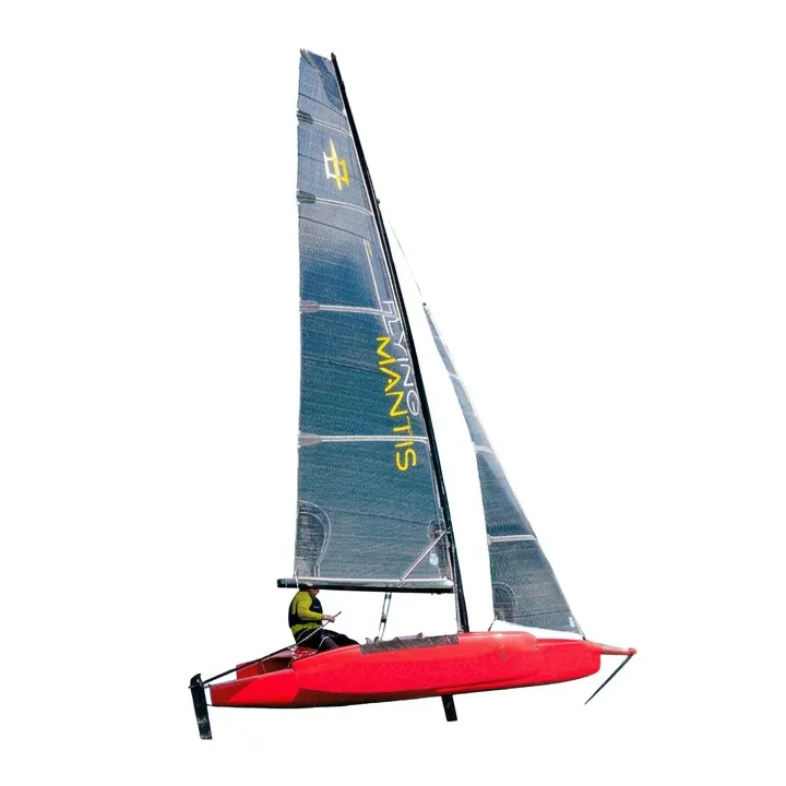 The Flying Mantis trimaran sailing on its foils, its red hull lifted clear of the water, black carbon sails carrying the yellow Flying Mantis name, with a single helm hiking out.