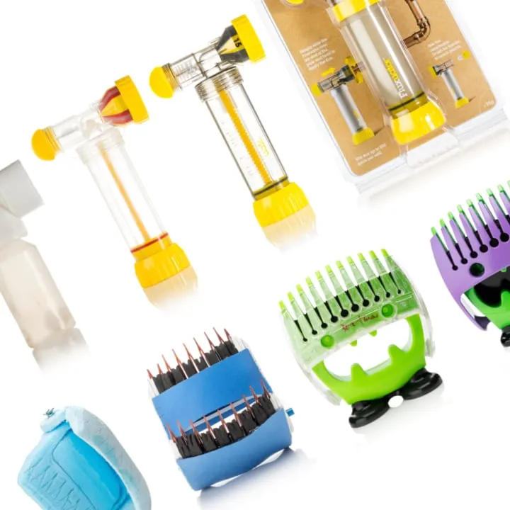 A cropped grid of early Fluxuator and Hairmoji prototypes against white: the Fluxuator's clear plumbing flux dispensers and retail pack above a foam mock-up and working Hairmoji combs in green and purple.