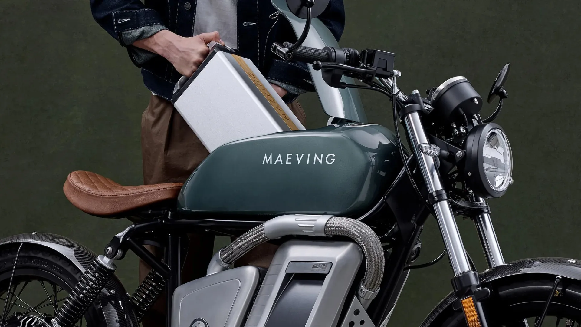 Sliding the removable battery into the Maeving electric motorcycle